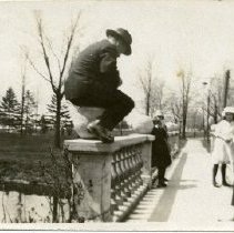 Unidentified Man Sitting on Bridge